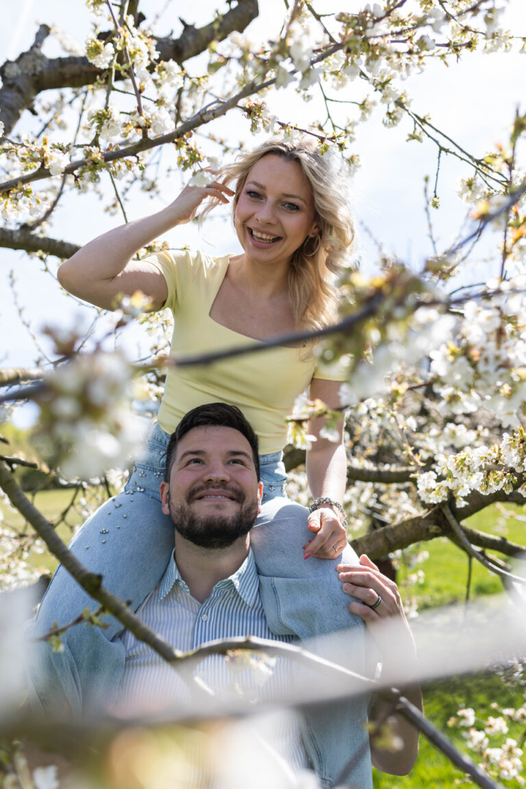 Paarportrait unter einem blühenden Kirschbaum